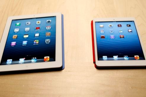 The new iPad mini is shown next to a full sized model at an Apple event in San Jose